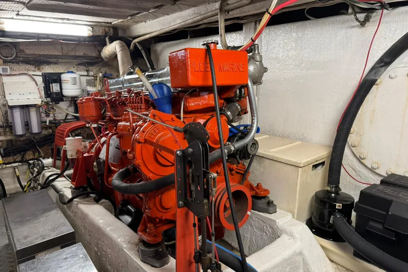 Slide: The Image of Engine room of a 1976 Cheoy Lee 40 LRC with a red marine engine. - 63