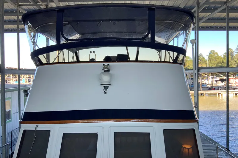 Slide: The Image of 1976 Cheoy Lee 40 LRC yacht docked in a covered marina. - 9