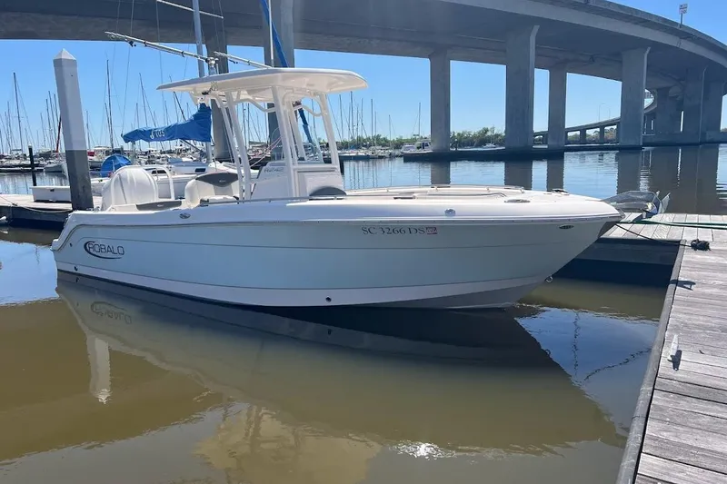 Slide: The Image of 2022 Robalo R242 Center Console boat docked in marina under bridge. - 6