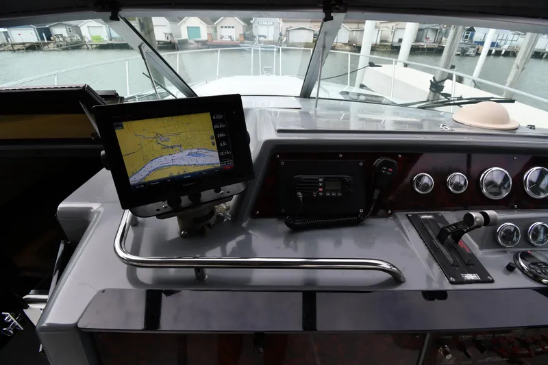 Slide: The Image of 1990 Formula boat dashboard with navigation screen and control panel. - 11