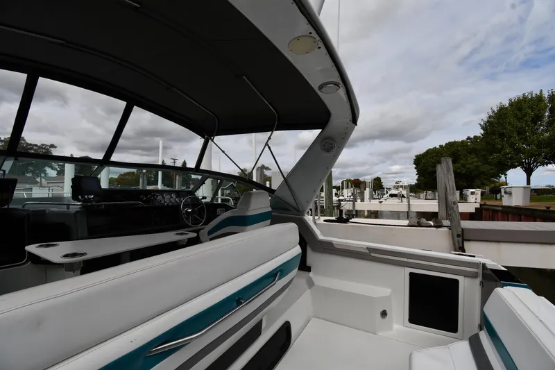 Slide: The Image of Interior of a 1990 Formula boat docked at a marina under cloudy skies. - 13