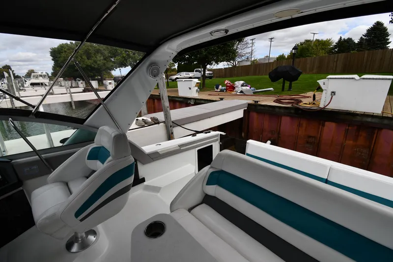Slide: The Image of Interior of a 1990 Formula boat docked at a marina with outdoor seating. - 16