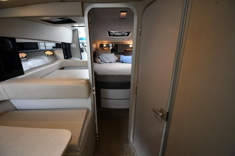 Slide: The Image of Interior of a 1990 Formula boat with cozy seating and a bedroom. - 18