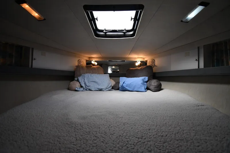 Slide: The Image of Cozy interior of a 1990 Formula boat cabin with pillows and overhead lighting. - 19