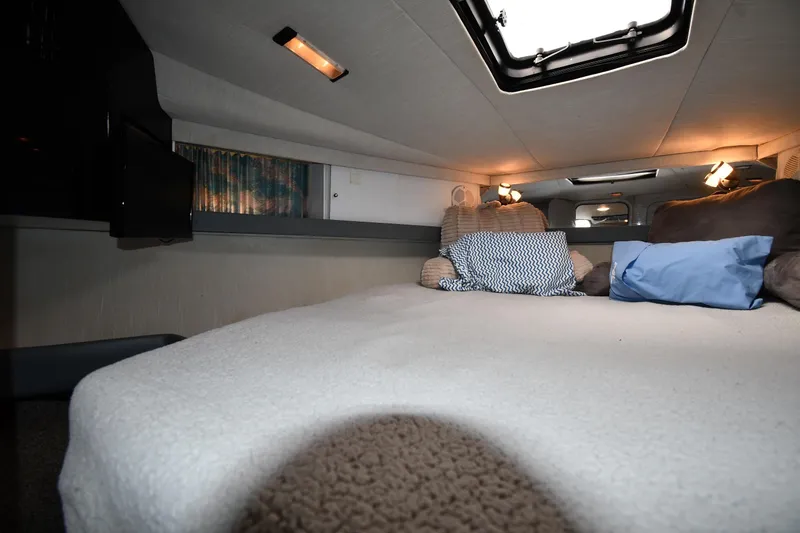 Slide: The Image of Cozy interior of a 1990 Formula boat cabin with pillows and soft lighting. - 21