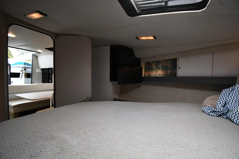 Slide: The Image of Interior of a 1990 Formula boat cabin with cozy bedding and modern lighting. - 22