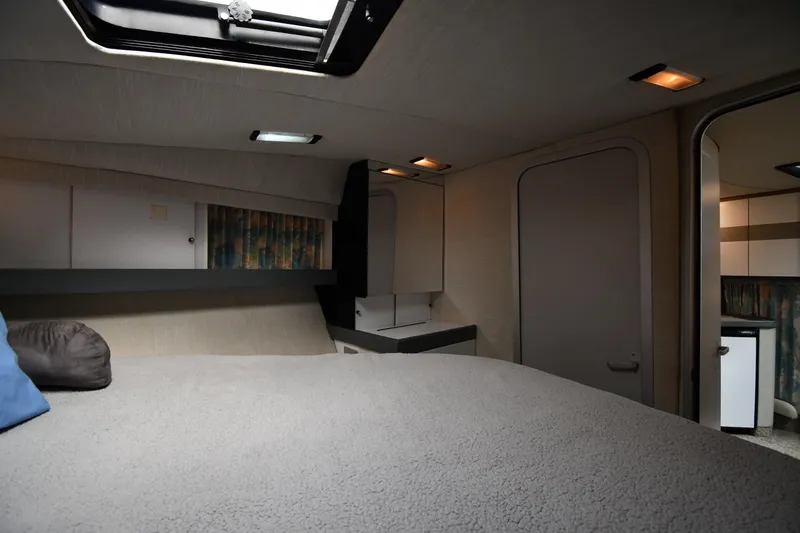 Slide: The Image of Cozy interior of a 1990 Formula boat cabin with bed and storage. - 23