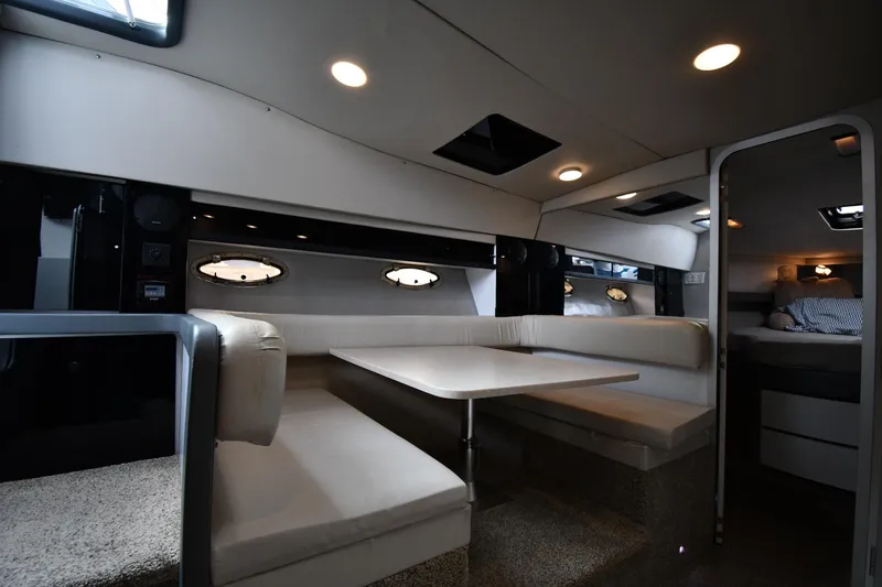 Slide: The Image of Interior of a 1990 Formula boat with cozy seating and modern lighting. - 28
