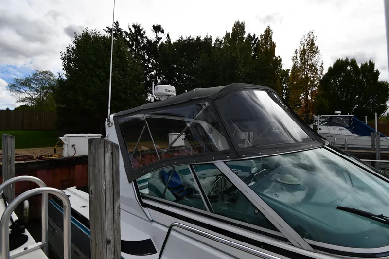 Slide: The Image of 1990 Formula boat docked, featuring a sleek windshield and Garmin equipment. - 3