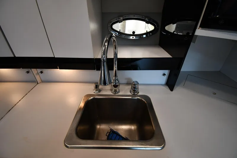 Slide: The Image of Modern kitchen sink with chrome faucet in a 1990 Formula boat interior. - 32