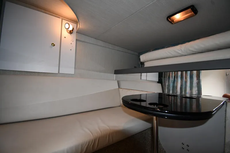 Slide: The Image of 1990 Formula boat interior with cozy seating, table, and ambient lighting. - 36