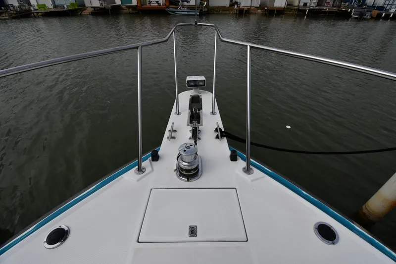 Slide: The Image of Bow of a 1990 Formula boat docked on calm water. - 4