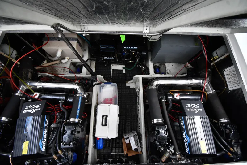 Slide: The Image of 1990 Formula boat engine compartment with dual MerCruiser 502 engines and wiring. - 40