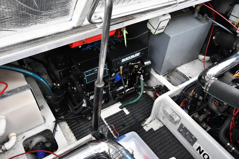 Slide: The Image of Engine compartment of a 1990 Formula boat, featuring Quicksilver components and various mechanical parts. - 42