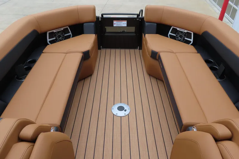 Slide: The Image of 2025 Princecraft Vogue 25 RL boat interior with tan seating and wood-patterned flooring. - 11
