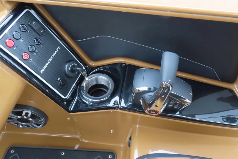Slide: The Image of Control panel of 2025 Princecraft Vogue 25 RL boat with throttle and cup holder. - 13