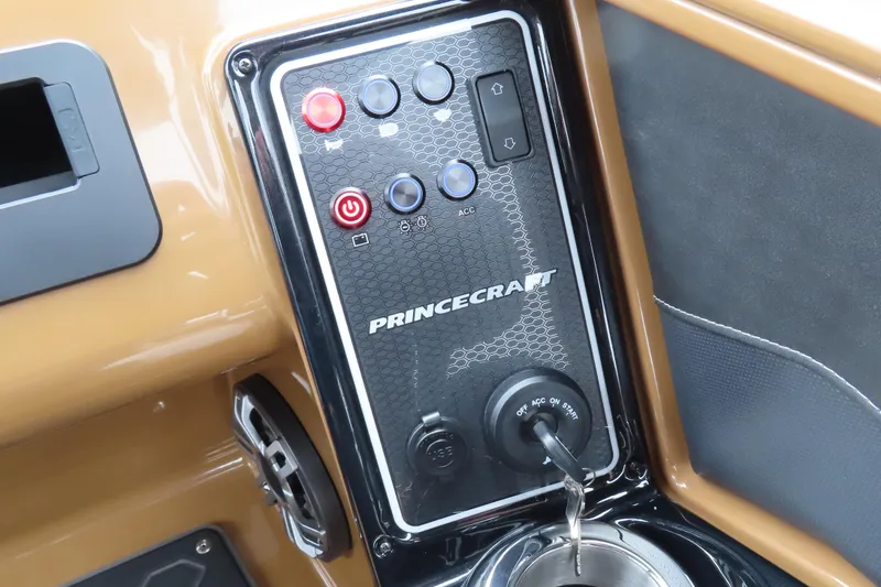 Slide: The Image of Control panel of 2025 Princecraft Vogue 25 RL boat with ignition key and buttons. - 16