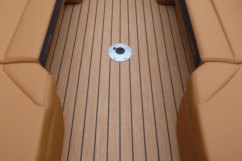 Slide: The Image of 2025 Princecraft Vogue 25 RL boat interior with tan seating and striped flooring. - 22