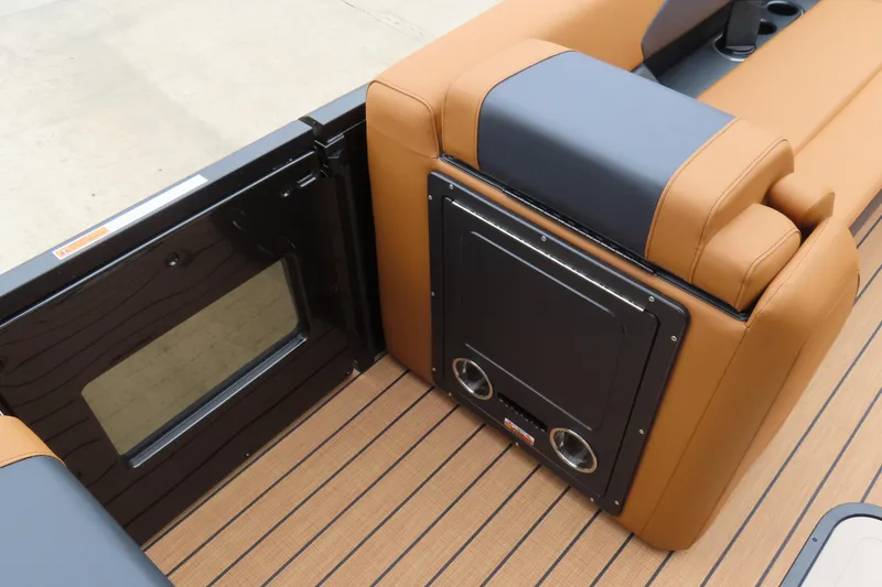 Slide: The Image of 2025 Princecraft Vogue 25 RL boat interior with tan and black seating and flooring. - 29