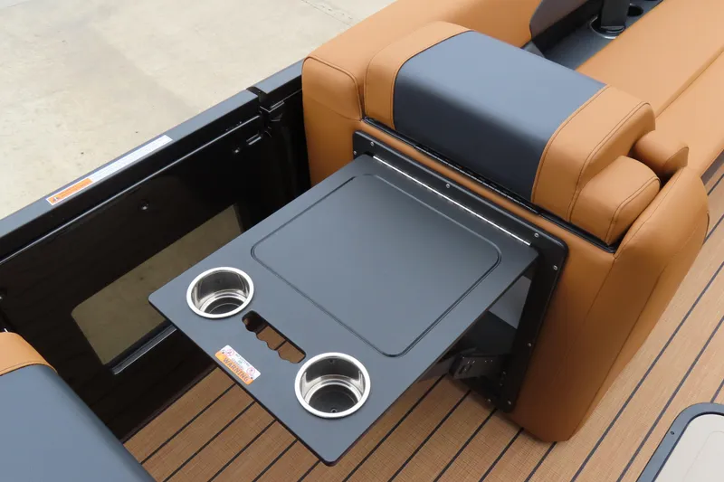 Slide: The Image of 2025 Princecraft Vogue 25 RL boat interior with fold-out table and cup holders. - 30