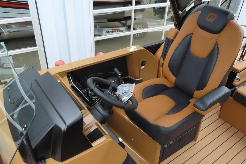 Slide: The Image of 2025 Princecraft Vogue 25 RL boat interior with luxurious captain's seat and steering console. - 31