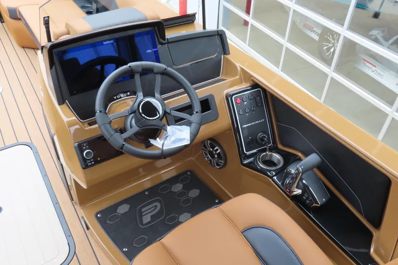 Slide: The Image of 2025 Princecraft Vogue 25 RL boat dashboard with steering wheel and control panel. - 34