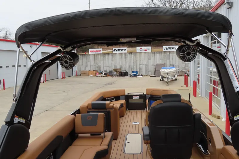 Slide: The Image of 2025 Princecraft Vogue 25 RL pontoon boat interior with seating and canopy in a marina setting. - 37