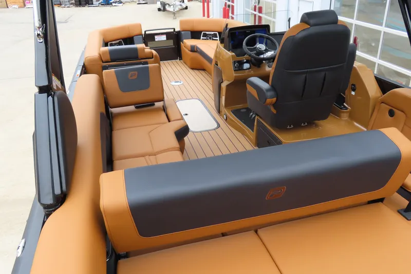 Slide: The Image of Luxurious interior of 2025 Princecraft Vogue 25 RL pontoon boat with tan and black seating. - 39