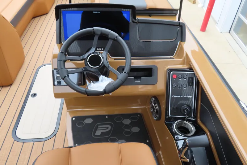 Slide: The Image of 2025 Princecraft Vogue 25 RL boat dashboard with steering wheel and control panel. - 43