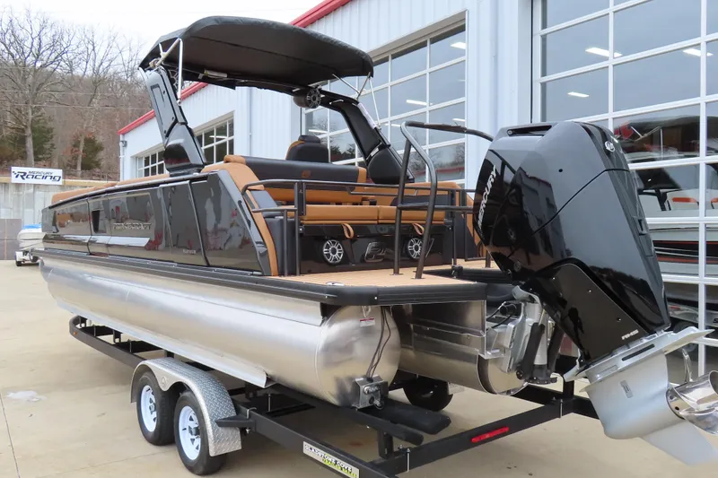 Slide: The Image of 2025 Princecraft Vogue 25 RL pontoon boat on trailer, featuring sleek design and powerful engine. - 7