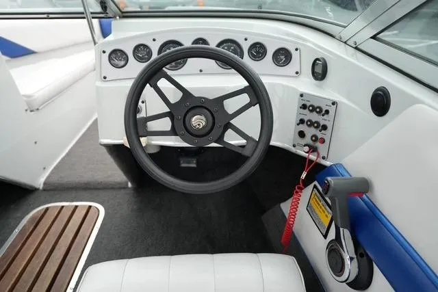 Slide: The Image of Steering wheel and dashboard of 1992 Celebrity 180 Bowrider boat interior. - 14