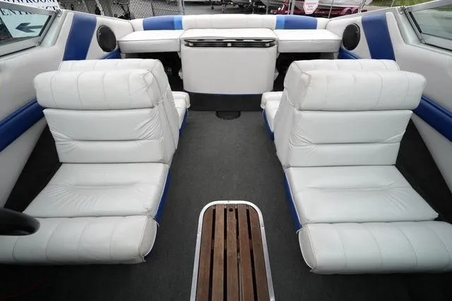 Slide: The Image of 1992 Celebrity 180 Bowrider interior with white and blue seating, wooden floor detail. - 15