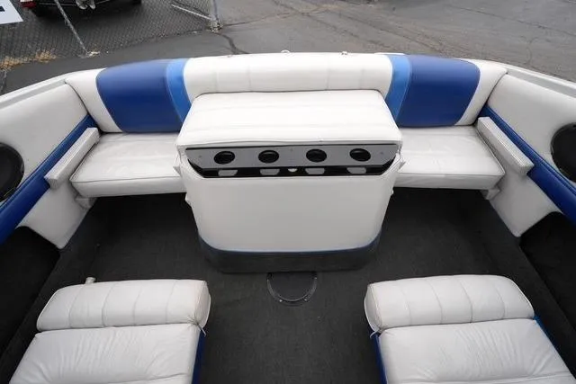 Slide: The Image of Interior of a 1992 Celebrity 180 Bowrider boat with white and blue seating. - 17