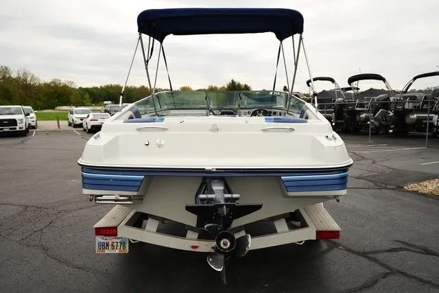 Slide: The Image of 1992 Celebrity 180 Bowrider boat, rear view, parked on a trailer in a lot. - 5