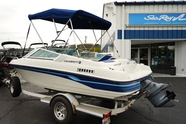 Slide: The Image of 1992 Celebrity 180 Bowrider boat on trailer, parked outside dealership. - 6
