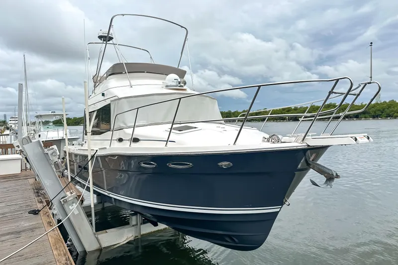 The Image of 2022 Cutwater 30 Command Bridge yacht docked by the water on a cloudy day. - 1