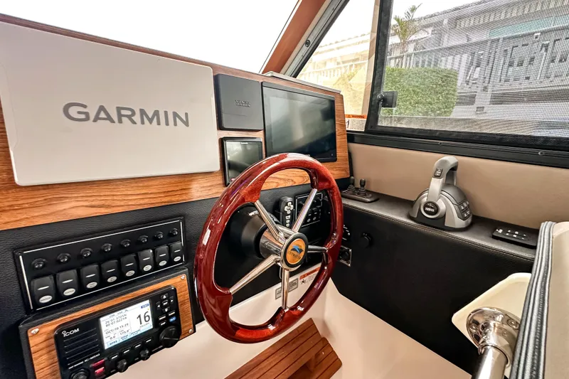 Slide: The Image of 2022 Cutwater 30 Command Bridge helm with Garmin navigation and wood accents. - 17
