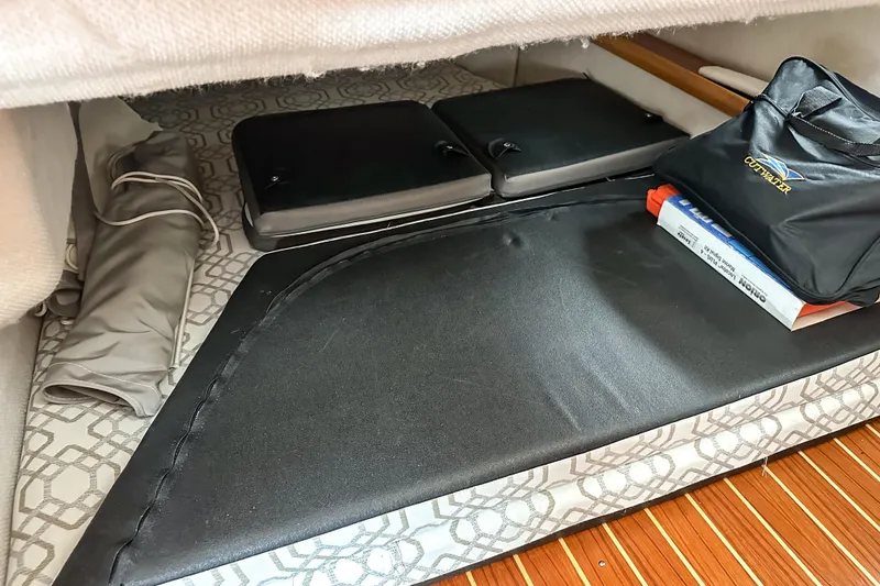 Slide: The Image of 2022 Cutwater 30 Command Bridge interior storage with cushions and accessories. - 22
