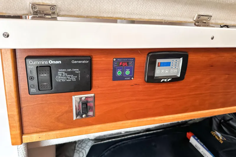 Slide: The Image of Control panel of a 2022 Cutwater 30 Command Bridge with generator and power charger. - 23