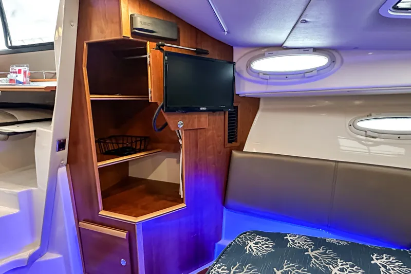 Slide: The Image of Interior of 2022 Cutwater 30 Command Bridge with TV and shelving. - 30