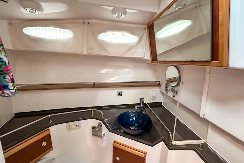 Slide: The Image of 2022 Cutwater 30 Command Bridge bathroom with modern sink and mirror. - 32
