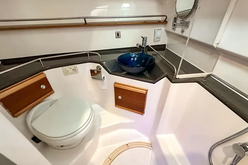 Slide: The Image of 2022 Cutwater 30 Command Bridge bathroom with modern sink and toilet. - 33