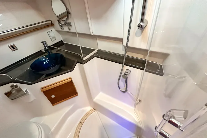 Slide: The Image of 2022 Cutwater 30 Command Bridge bathroom with modern sink and shower. - 34