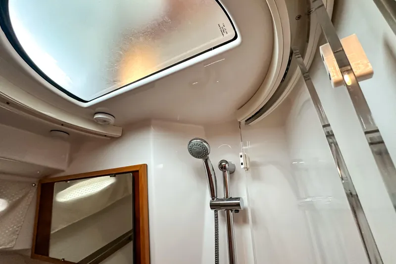 Slide: The Image of Interior shower area of 2022 Cutwater 30 Command Bridge boat, featuring skylight and modern fixtures. - 36