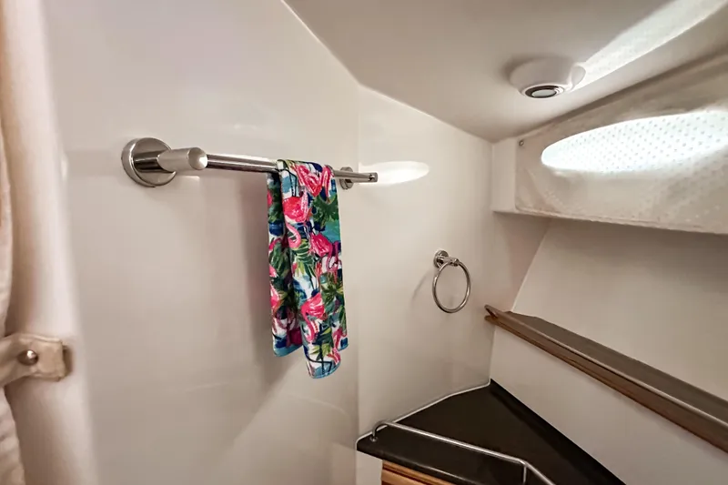 Slide: The Image of 2022 Cutwater 30 Command Bridge bathroom with towel rack and colorful towel. - 37