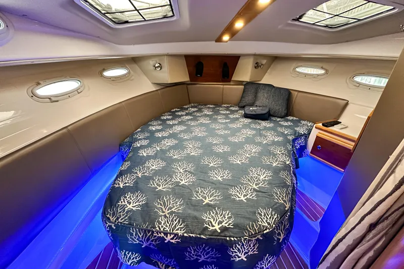 Slide: The Image of 2022 Cutwater 30 Command Bridge cabin with elegant bedding and ambient lighting. - 39