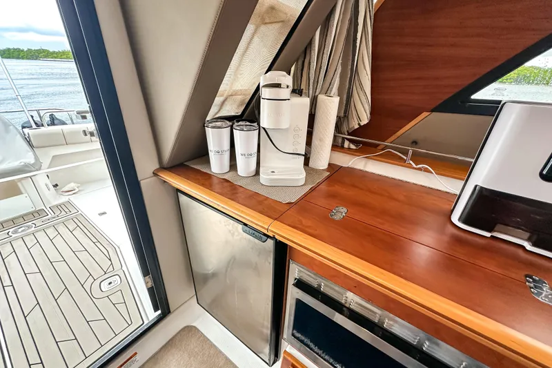 Slide: The Image of Interior of 2022 Cutwater 30 Command Bridge with kitchenette and lake view. - 46