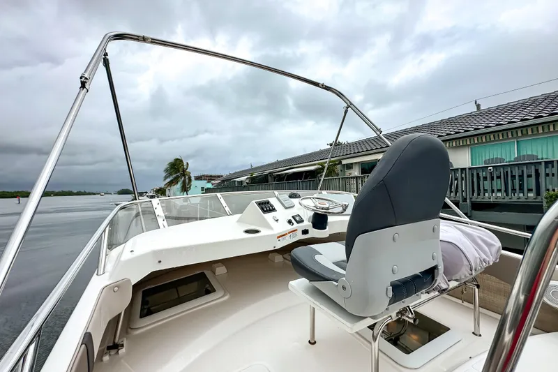 Slide: The Image of 2022 Cutwater 30 Command Bridge boat interior with steering wheel and captain's chair. - 49