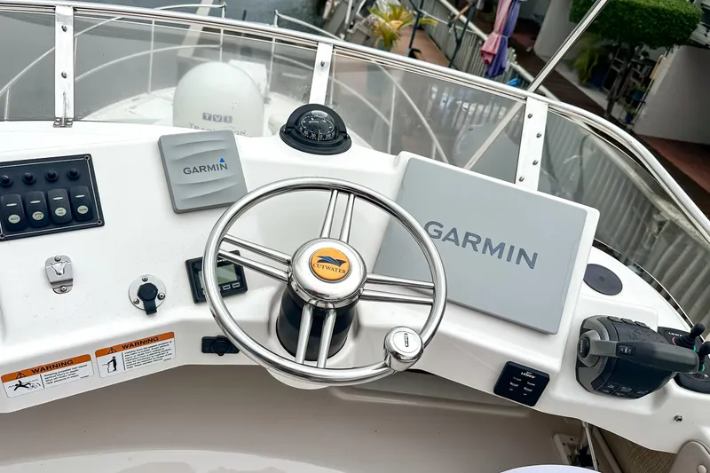 Slide: The Image of 2022 Cutwater 30 Command Bridge helm with Garmin navigation system and steering wheel. - 50
