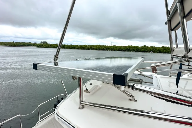 Slide: The Image of 2022 Cutwater 30 Command Bridge with solar panel on deck, overlooking serene waters. - 57